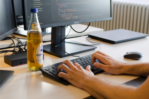 A person typing on a computer in an office